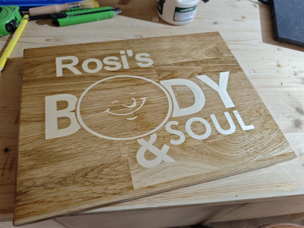 Rosi's Body & Soul – Detail – Nahaufnahme: sauber ausgefräste Buchstaben und das eingravierte Logo.